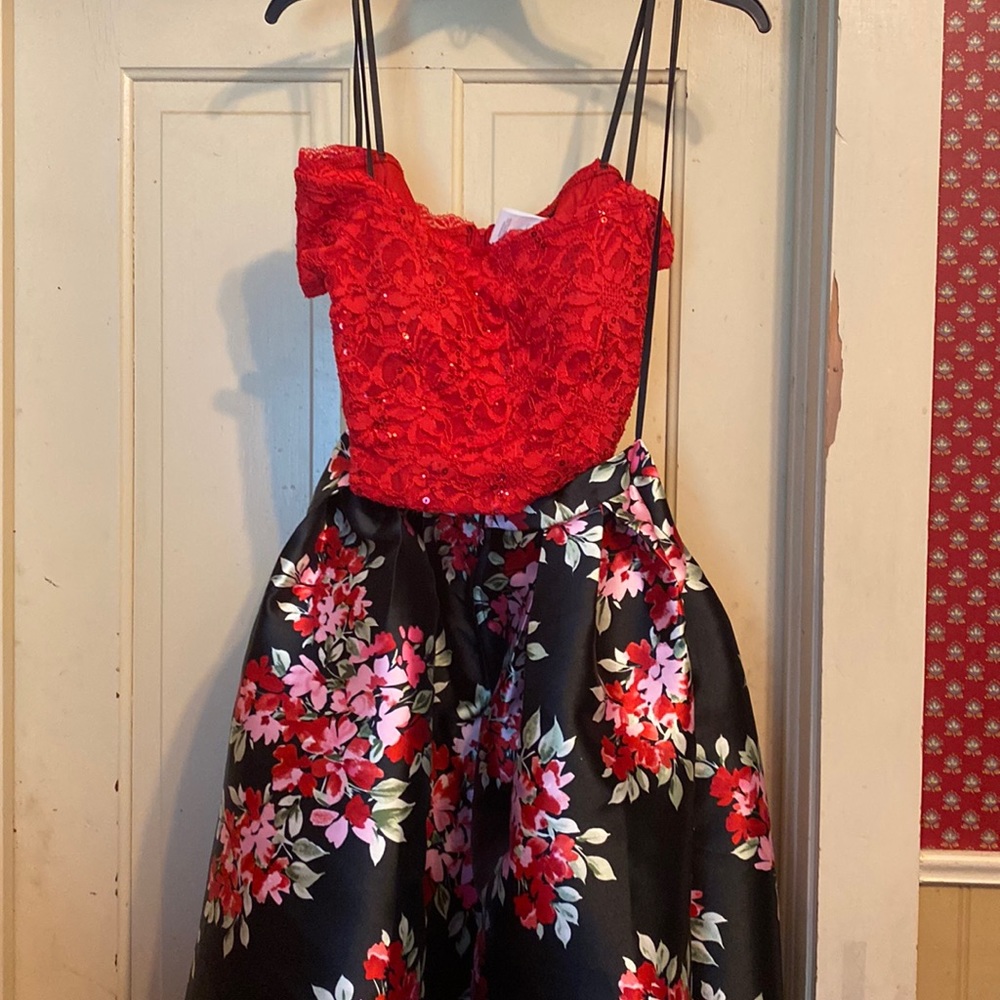 This is a two piece B. Darlin prom dress with a red top and floral skirt